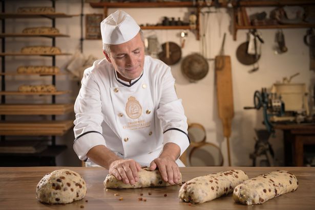 The dough pieces are formed into Christmas stollen.